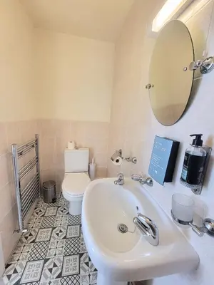 a bathroom with a sink and a toilet at Kings House in Douglas
