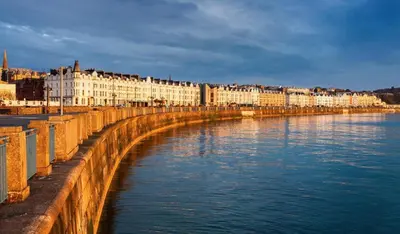 a row of buildings next to a body of water at Kings House in Douglas
