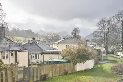 a group of houses with a fence and a yard at Host & Stay - Trinity Way in Keswick