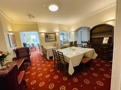a dining room with two tables and a piano at Fairlight Guesthouse in Glenridding