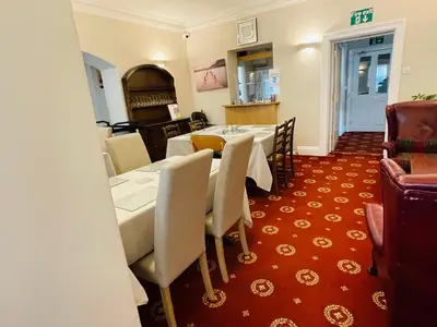 a dining room with a table and chairs in a room at Fairlight Guesthouse in Glenridding