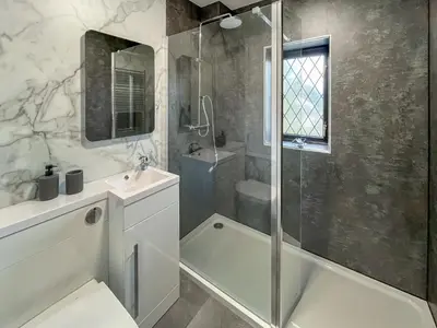 a bathroom with a shower and a sink and a tub at Hindsgarth in Keswick