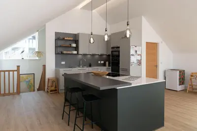 a kitchen with a black island in a room at 2 Kippford Slipway in Kippford