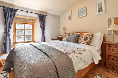 a bedroom with a bed and a window at Finest Retreats - St Francis Cottage in Ulpha