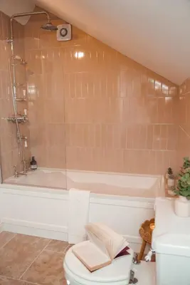 a bathroom with a tub and a toilet and a sink at Riverside Country House and Cottage in Sunderland