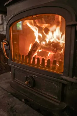 a stove with a fire in it at Riverside Country House and Cottage in Sunderland