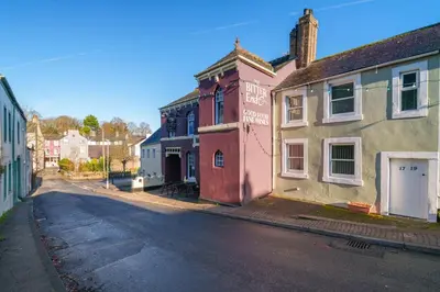 an empty street in a town with colorful buildings at Bell Cottage - Cockermouth is five minutes walk to pubs, restaurants and shops in Cockermouth