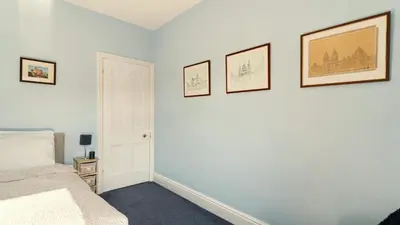 a bedroom with a bed and three pictures on the wall at Stanley House in Bassenthwaite
