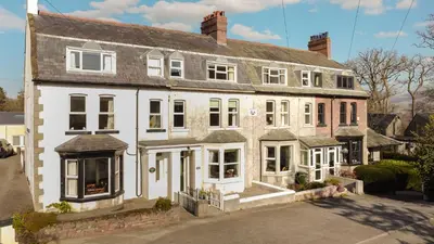 a large white brick house with white windows at Stanley House in Bassenthwaite