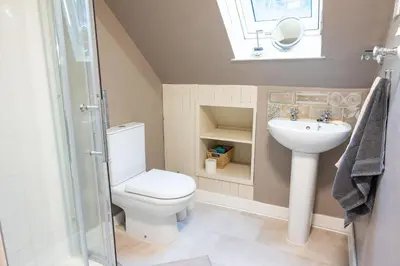 a bathroom with a toilet and a sink at Gardeners Cottage in Auchencairn