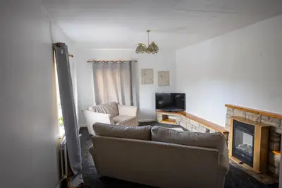 a living room with a couch and a fireplace at Charming 2br Maisonette In Carlisle Center in Carlisle