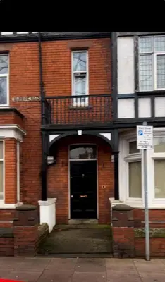a brick building with a black door and a balcony at Warwick Studio Spaces in Carlisle