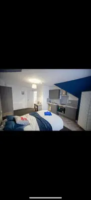 a bedroom with two beds and a desk in it at Warwick Studio Spaces in Carlisle