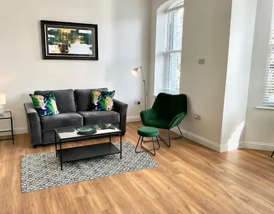 a living room with a couch and a chair at 8 Clifton Terrace in Douglas
