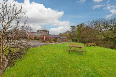 two benches sitting in the grass in a field at 3 Bed in Waberthwaite oc-d31079 in Waberthwaite