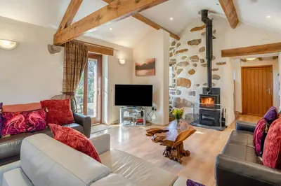 a living room with a couch and a fireplace at 3 Bed in Waberthwaite oc-d31079 in Waberthwaite