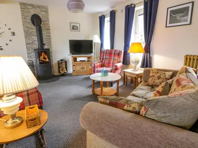 a living room with a couch and a fire place at The Lamphouse in Stranraer
