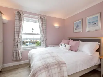 a bedroom with a bed and a window at Holiday Home The Knowe by Interhome in Portpatrick