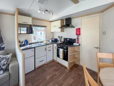 a small kitchen with a stove and a sink at The Haven in Cockermouth