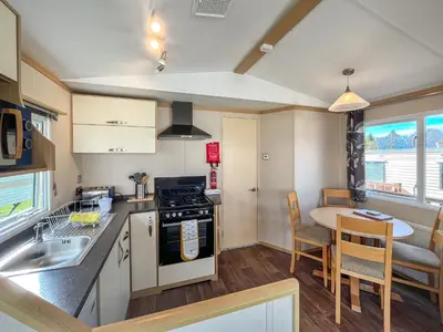 a kitchen and dining room with a table and chairs at The Haven in Cockermouth