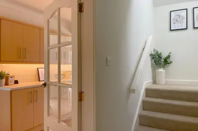 a room with a staircase and a stair case at Fern Cottage in Portinscale