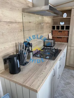 a kitchen with a stove and a counter top at Amblers Hide, Brigham, Cockermouth, Cumbria in Cockermouth