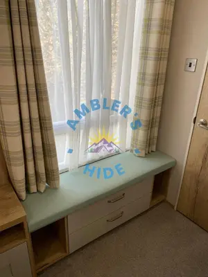 a window with a childs sign in front of it at Amblers Hide, Brigham, Cockermouth, Cumbria in Cockermouth