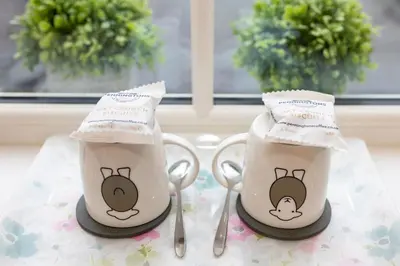 two coffee cups with hello kitty on them on a table at Raise View House in Ambleside