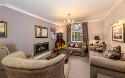 a living room with couches and a fireplace at Raise View House in Ambleside