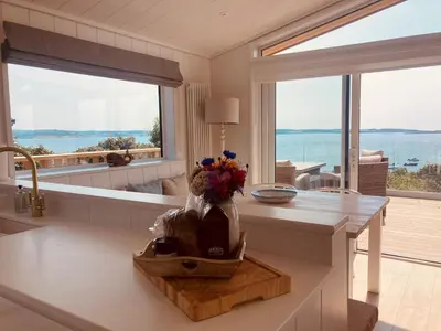 a kitchen with a counter with a vase of flowers at The Moorings in Girthon