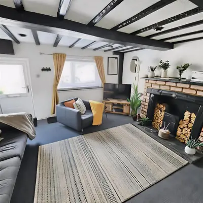 a living room with a couch and a fireplace at Leaf Tree Cottage, close to Coast, Lakes and Fells in Workington