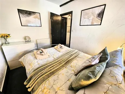 a bedroom with a bed with pillows on it at Leaf Tree Cottage, close to Coast, Lakes and Fells in Workington