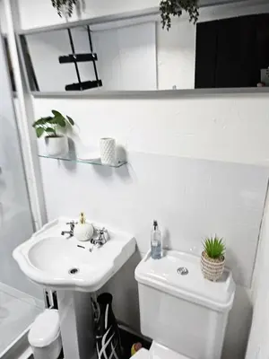a white bathroom with a sink and a toilet at Leaf Tree Cottage, close to Coast, Lakes and Fells in Workington