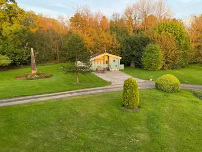 a small house in the middle of a yard at Rustic Secluded Hidden Gem At Rockhall in Dumfries