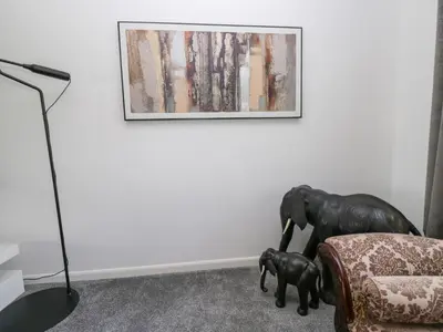 a living room with a couch and an elephant statue at Eildon Lodge in Seascale