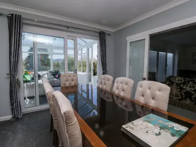 a living room with a dining room table and chairs at Eildon Lodge in Seascale