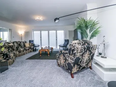 a living room with a couch and chairs and a table at Eildon Lodge in Seascale
