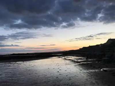 a view of a beach with a cloudy sky at Swallow Cottage in Dumfries