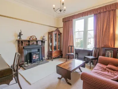 a living room with a couch and a fireplace at Hildawn in Dumfries