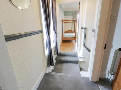 a hallway with a stairway leading into a room at Hildawn in Dumfries