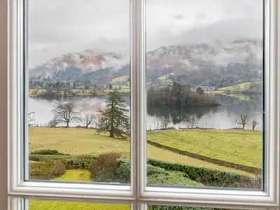 a window with a view of a lake and mountains at Huntingstile South in Ambleside