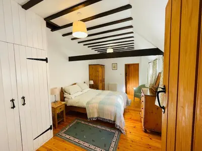 a bedroom with a bed in a room at Quaint Oxfordshire cottage on a peaceful farm in Moffat