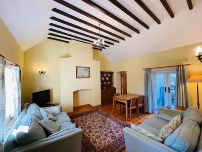 a living room with two couches and a table at Quaint Oxfordshire cottage on a peaceful farm in Moffat