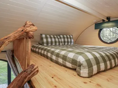 a bedroom in a cabin with a bed in it at Binsey Lodge in Wigton