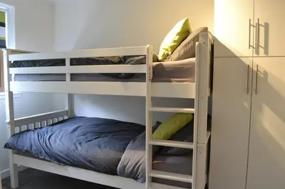 a bunk bed room with two bunk beds in a room at The Tranquil Orchard in Dumfries