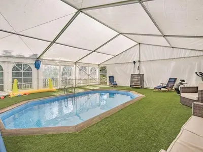 a large tent with a swimming pool in a yard at The Tranquil Orchard in Dumfries