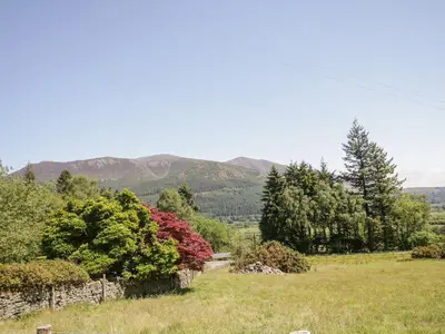 a view of a field with mountains in the background at Bramble Cottage in Keswick