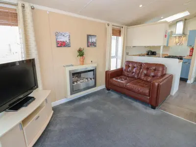 a living room with a leather chair and a television at New Horizon in Carlisle