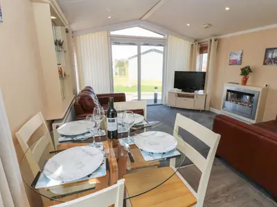 a dining room with a table with wine glasses on it at New Horizon in Carlisle