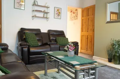a waiting room with leather chairs and a table at Open House in Carlisle